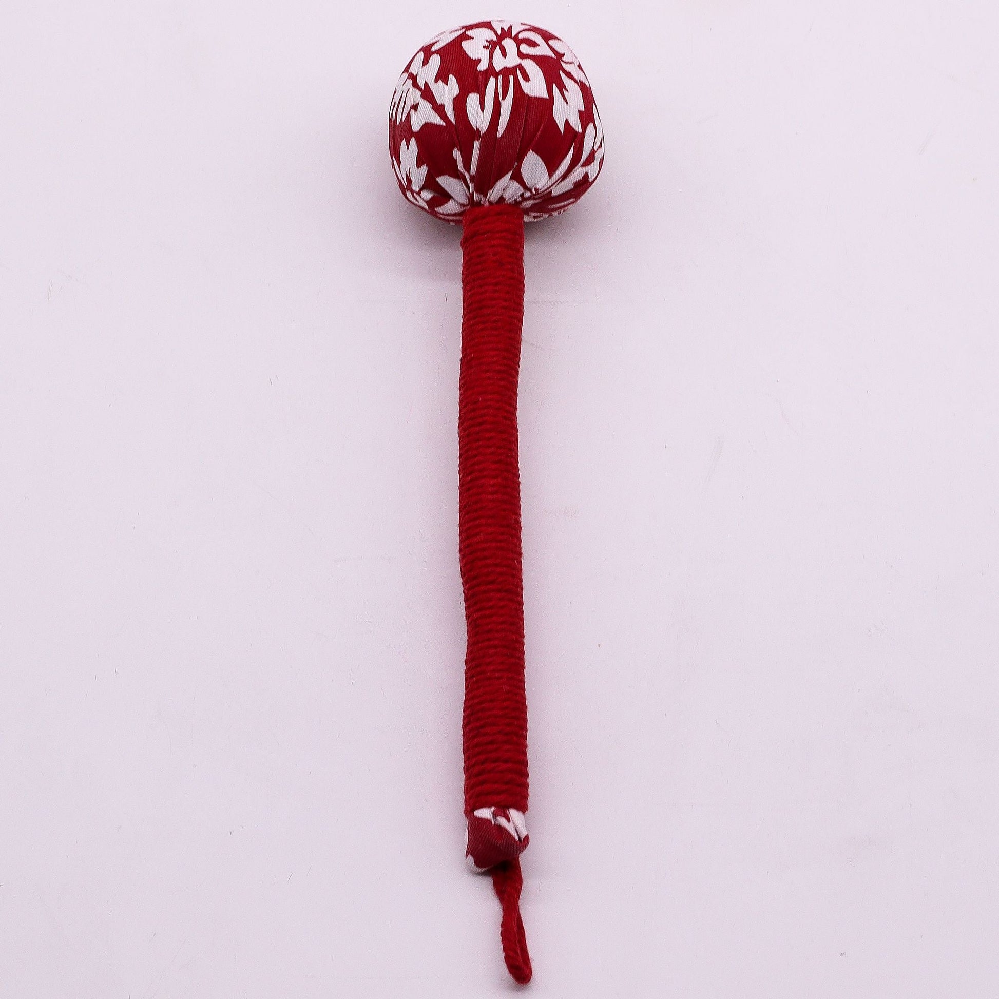 Alt Tag: Red Wormwood Massage Hammer – Wooden Tool with red wrapped handle and patterned head for rhythmic tapping massage