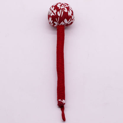 Alt Tag: Red Wormwood Massage Hammer – Wooden Tool with red wrapped handle and patterned head for rhythmic tapping massage