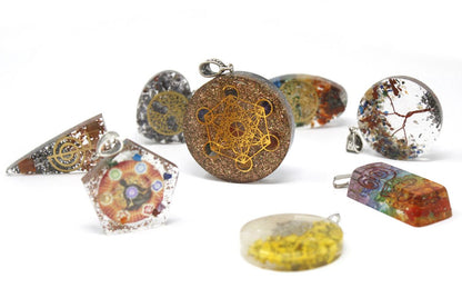 Alt Tag: Resin Orgonite Pendant – Symbolic Power Dome with resin, gemstones and metal filings, assorted geometric pendants on white