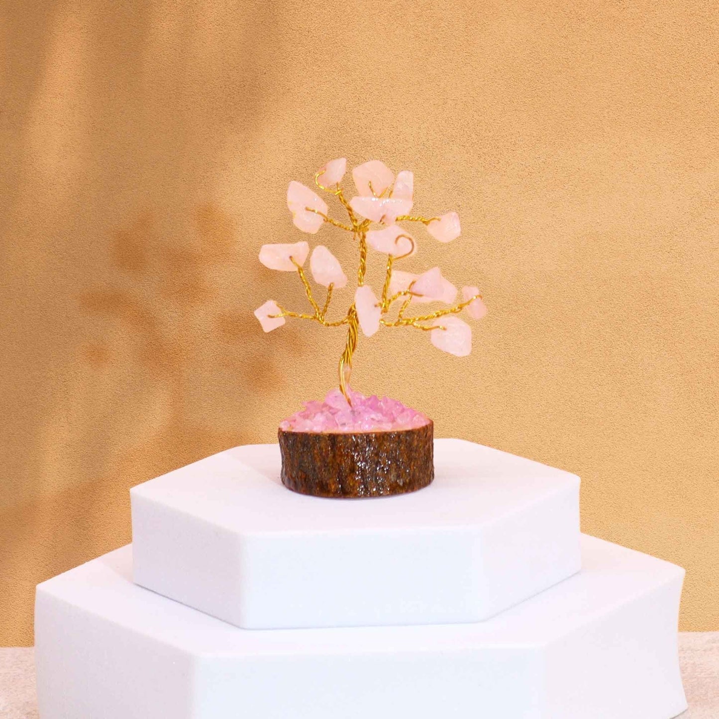 Rose Quartz Gemstone Tree – Mini 6CM, 15 Stones decor on wooden base with rose quartz chips, displayed on white pedestal