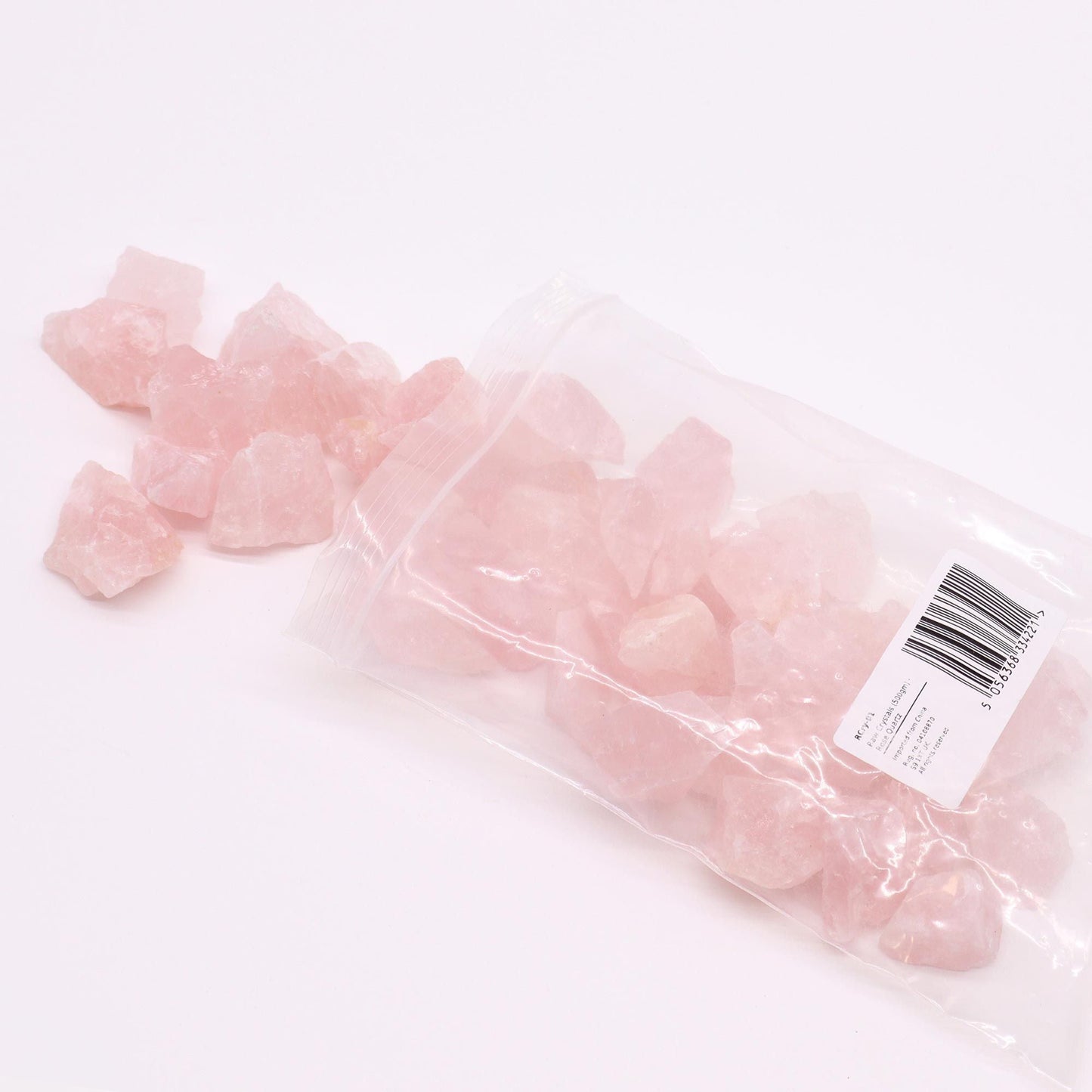 Rosenquarz-Edelstein – 500GM Rohkristalle im transparenten Beutel, rohe Rosenquarzsteine auf weißem Hintergrund