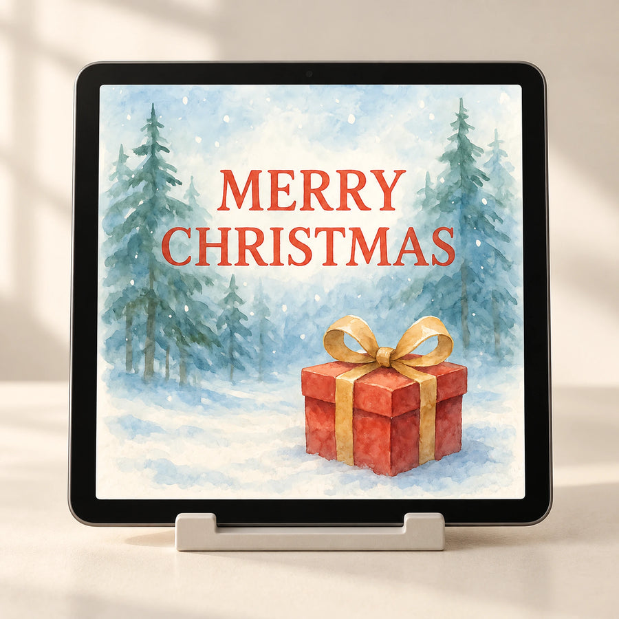 Staged tablet preview of Saga Bliss Christmas artwork, showing “MERRY CHRISTMAS”, snowy evergreen trees and a painted gift.