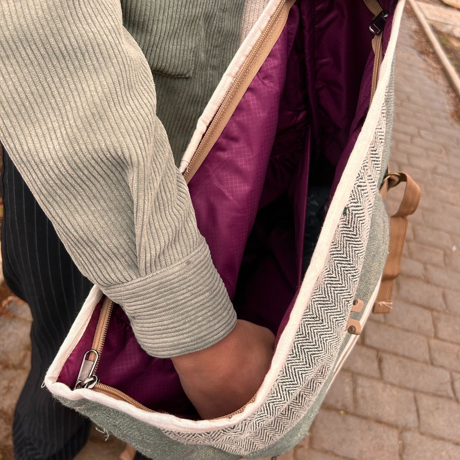 Sage Trekking Rolling Backpack – Hemp & Cotton Canvas open top view showing interior lining and hand placing items inside