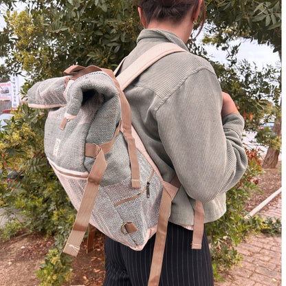 Alt Tag: Sage Trekking Rolling Backpack – Hemp & Cotton Canvas worn outdoors, sage canvas backpack with beige straps and flap top
