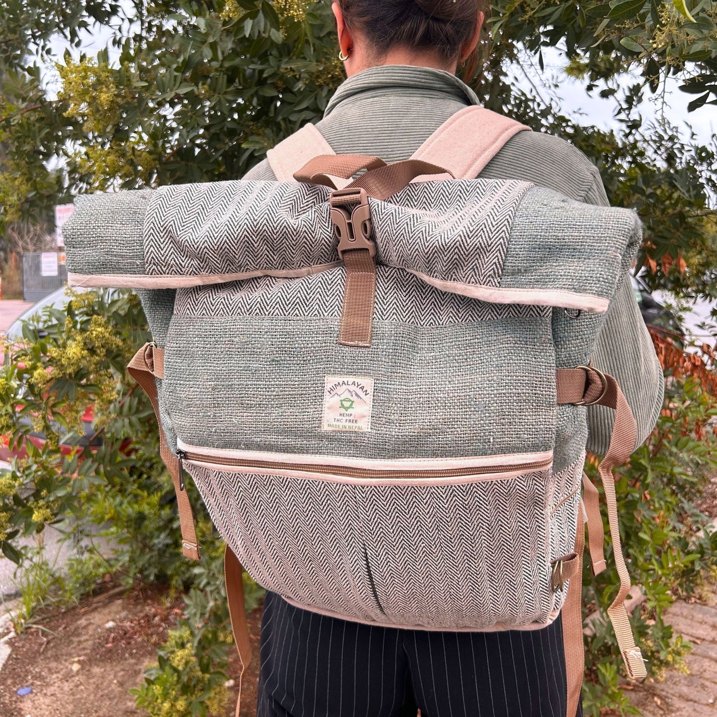Alt Tag: Sage Trekking Rolling Backpack – Hemp & Cotton Canvas in sage, roll-top canvas backpack with straps, worn outdoors