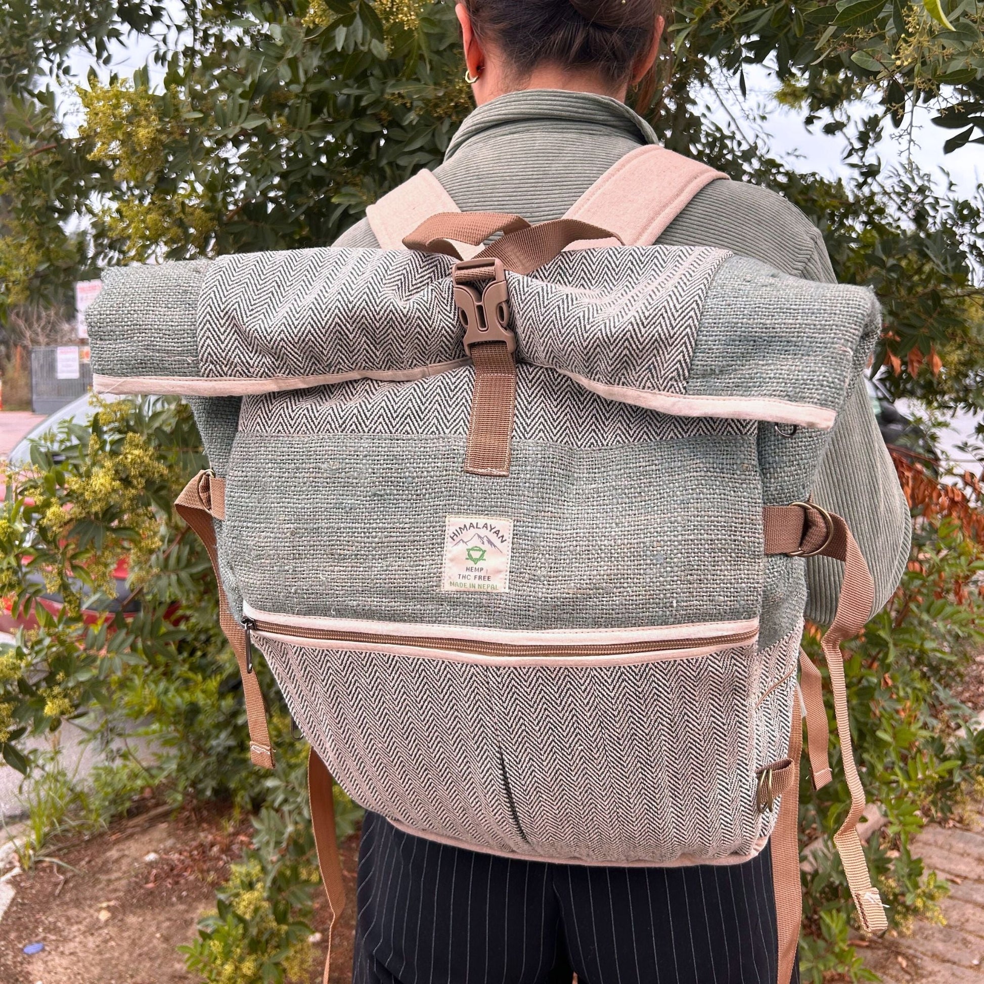 Alt Tag: Sage Trekking Rolling Backpack – Hemp & Cotton Canvas in sage, roll-top canvas backpack with straps, worn outdoors