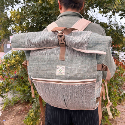Alt Tag: Sage Trekking Rolling Backpack – Hemp & Cotton Canvas in sage, roll-top canvas backpack with straps, worn outdoors