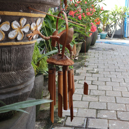 Seagrass Bamboo Wind Chime – Natural Coconut Dragon hanging outdoors with bamboo tubes and coconut dragon design