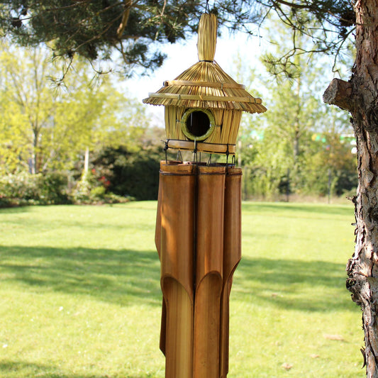 Seagrass Bird Box with Chimes – 56x20 CM hanging on a tree in a garden, natural seagrass and bamboo birdhouse with chimes