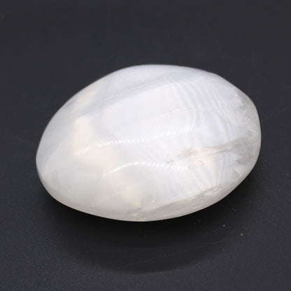 Alt Tag: Selenite Palm Stone – 5-7 CM white polished selenite palm stone with silky sheen on dark background