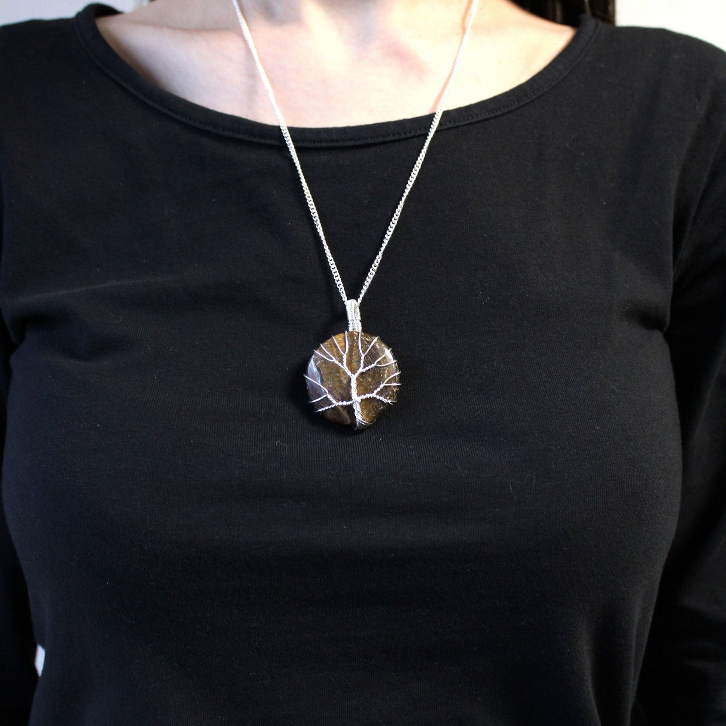 Silver Plated Tree of Life Necklace – Tiger Eye on model, silver-plated chain with round tiger eye tree of life pendant