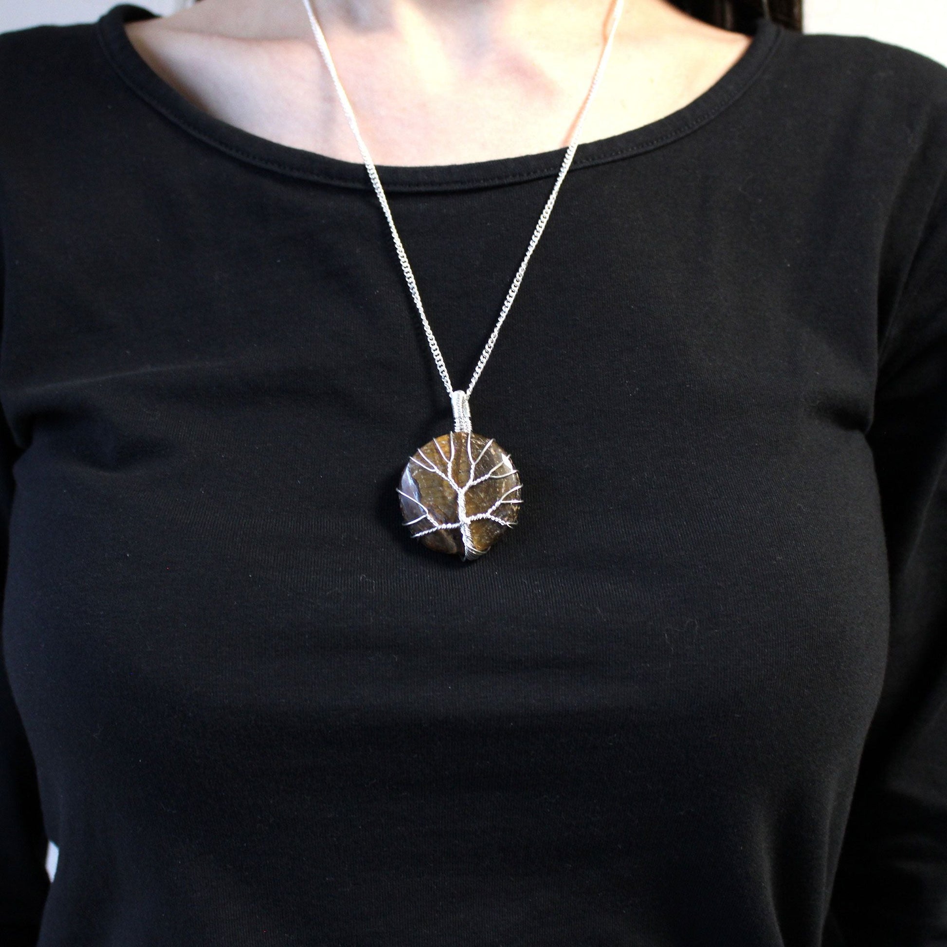Silver Plated Tree of Life Necklace – Tiger Eye on model, silver-plated chain with round tiger eye tree of life pendant