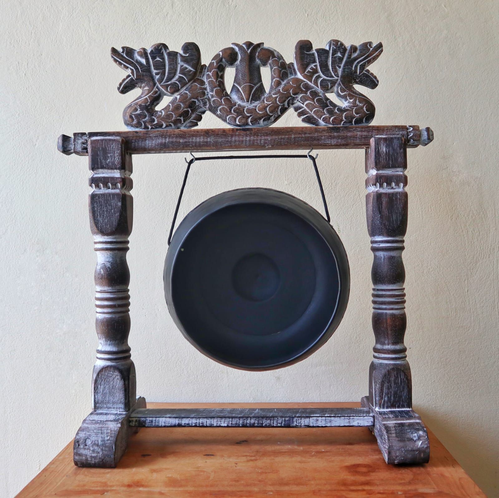 Small Harmonizing Gong in Stand – 25 CM – Black hanging in carved wooden stand, black finish gong on tabletop