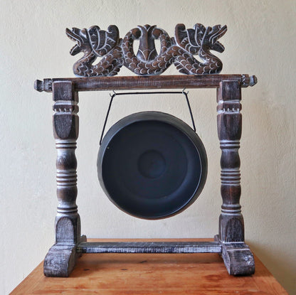 Small Harmonizing Gong in Stand – 25 CM – Black hanging in carved wooden stand, black finish gong on tabletop
