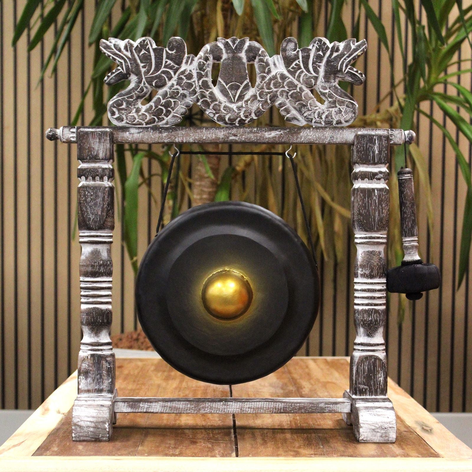 Small Harmonizing Gong in Stand – 25 CM – Black on carved wooden stand with mallet, front view black gong with gold center
