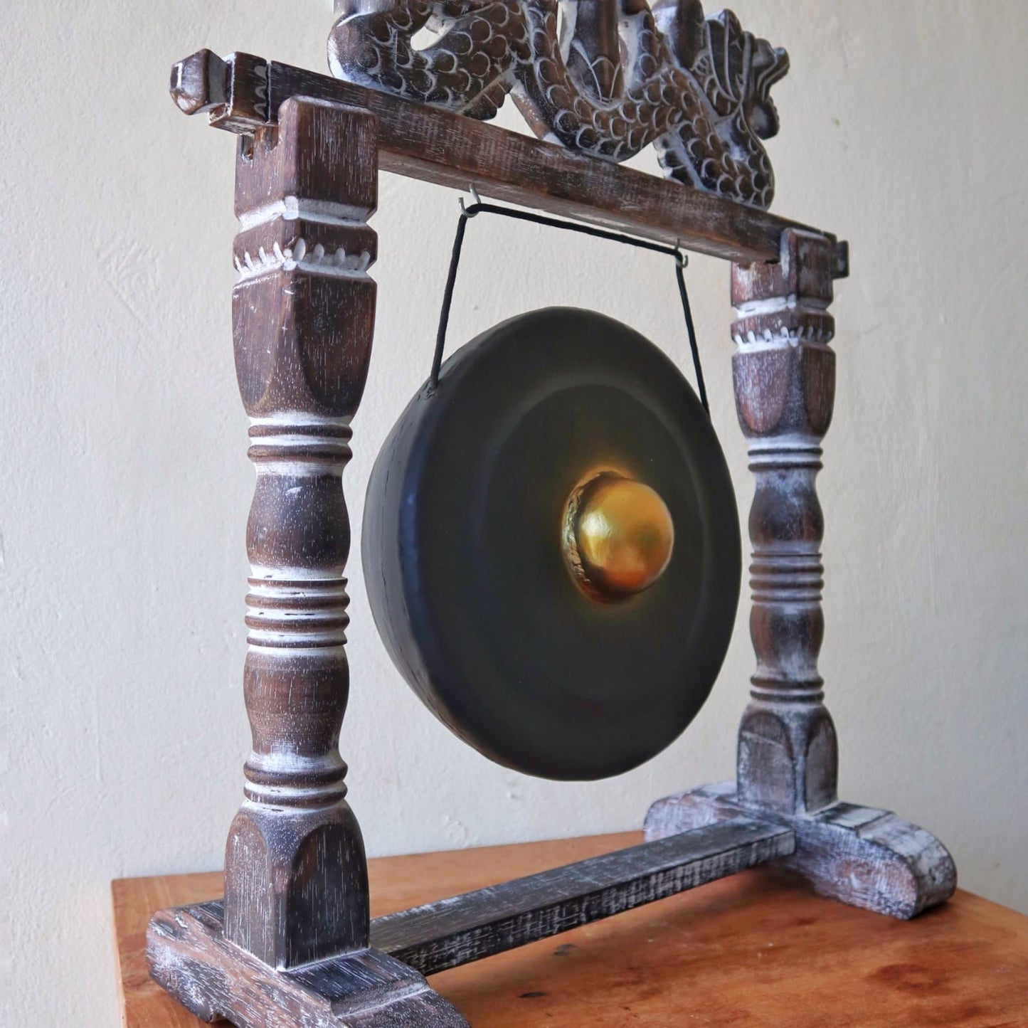 Small Harmonizing Gong in Stand – 25 CM – Black hanging on carved wooden stand with black gong and gold center, tabletop display