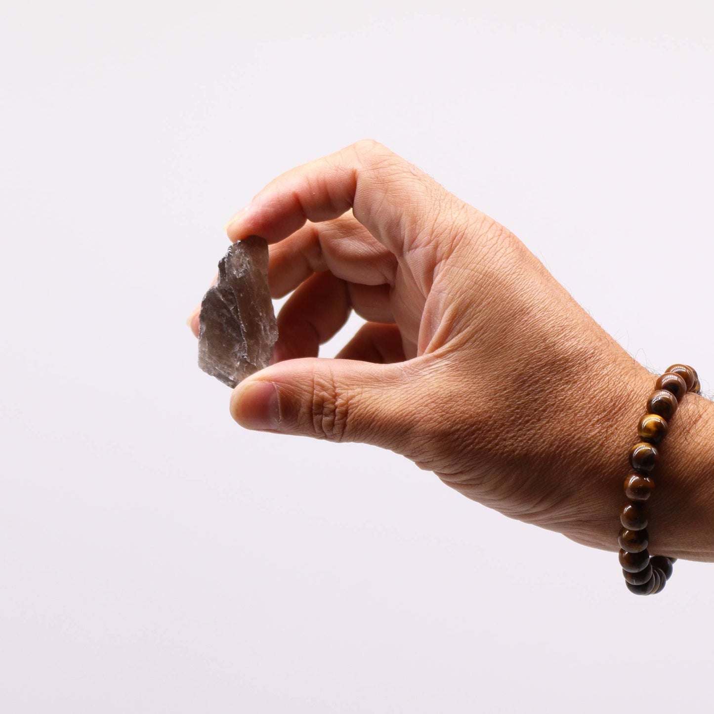 Smoky Quartz Raw Crystals – 500G Gemstone Collection, hand holding a natural smoky quartz rough stone close-up