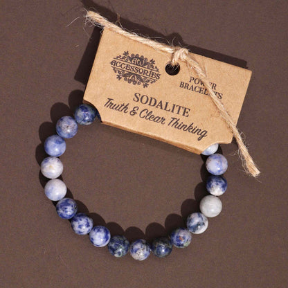 Alt Tag: Sodalite Gemstone Power Bracelet – 8MM with polished blue sodalite beads and accessory tag on dark background