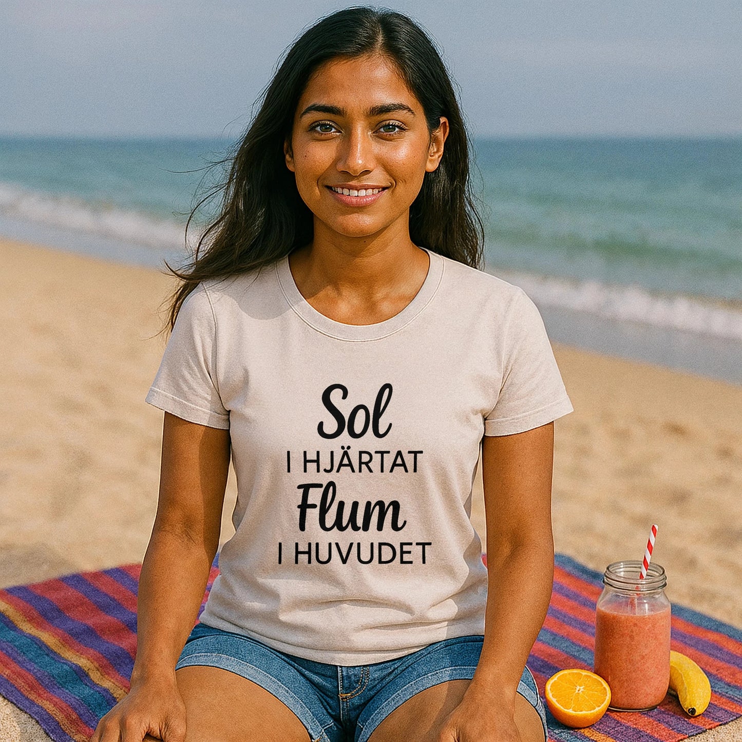 Alt Tag: Sol I Hjärtat Flum I Huvudet 100% Organic Cotton T-Shirt worn by woman on beach, cream tee with Swedish text print