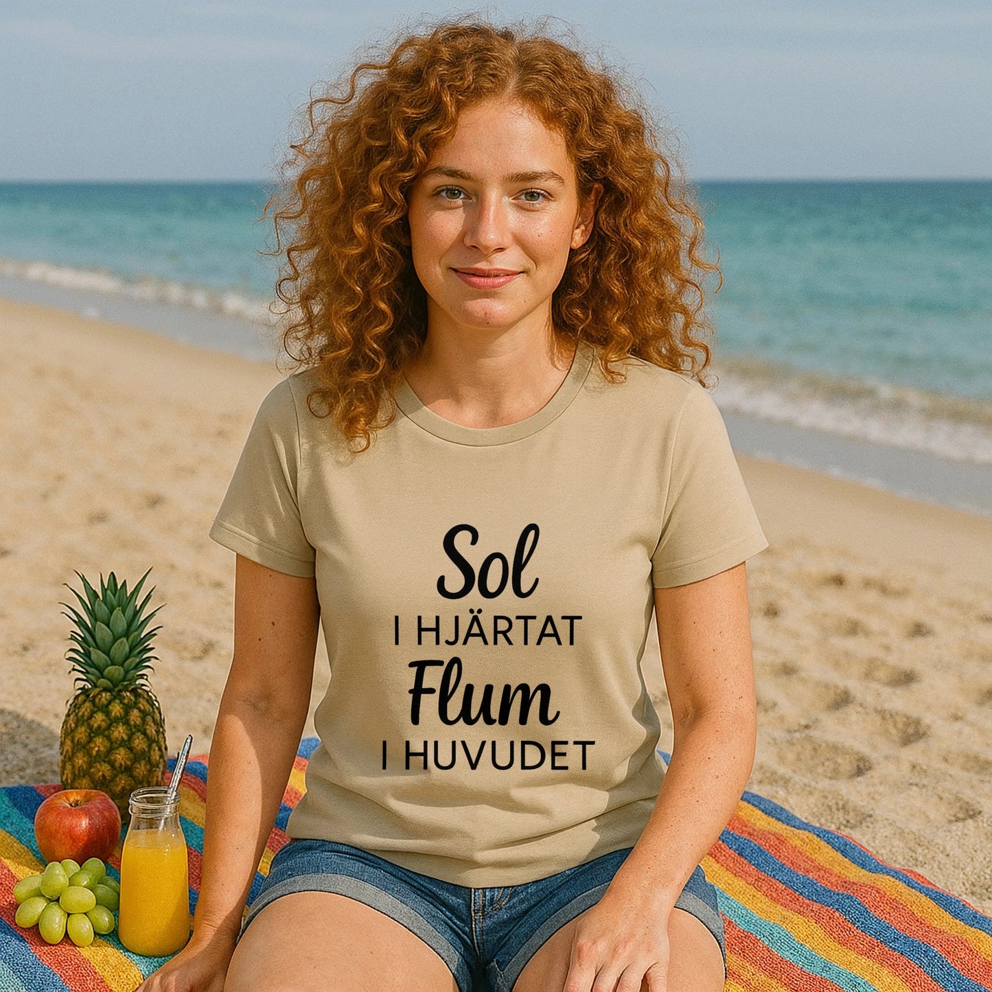 Model wearing Sol I Hjärtat Flum I Huvudet 100% Organic Cotton T-Shirt on beach, beige tee with black text print