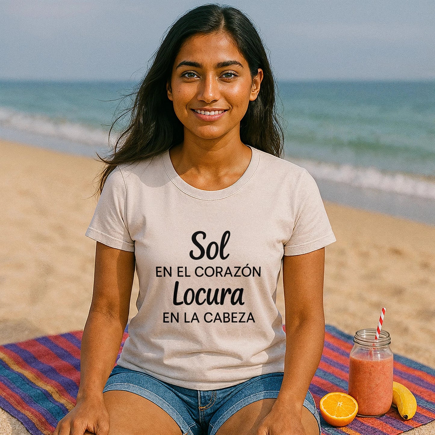 Alt Tag: Sol Locura 100% Organic Cotton T-Shirt en modelo sentada en la playa, camiseta beige con texto “Sol Locura”