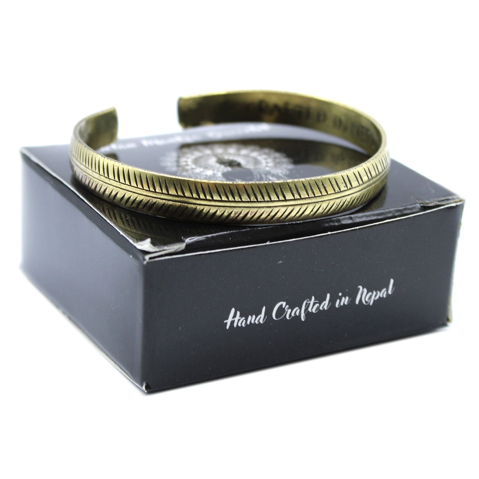 Alt Tag: Solid Brass Tibetan Mantra Bracelet – Slim Tribal Leaf brass cuff bracelet with tribal leaf pattern on black gift box