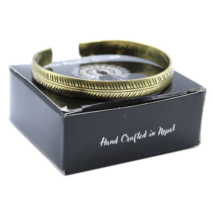 Alt Tag: Solid Brass Tibetan Mantra Bracelet – Slim Tribal Leaf brass cuff bracelet with tribal leaf pattern on black gift box