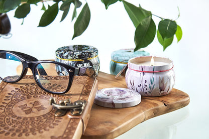 Soy Wax Art Tin Candle – Parisian Weekend soy wax candle in decorative tin with lid on wooden tray, beside open candle and glasses