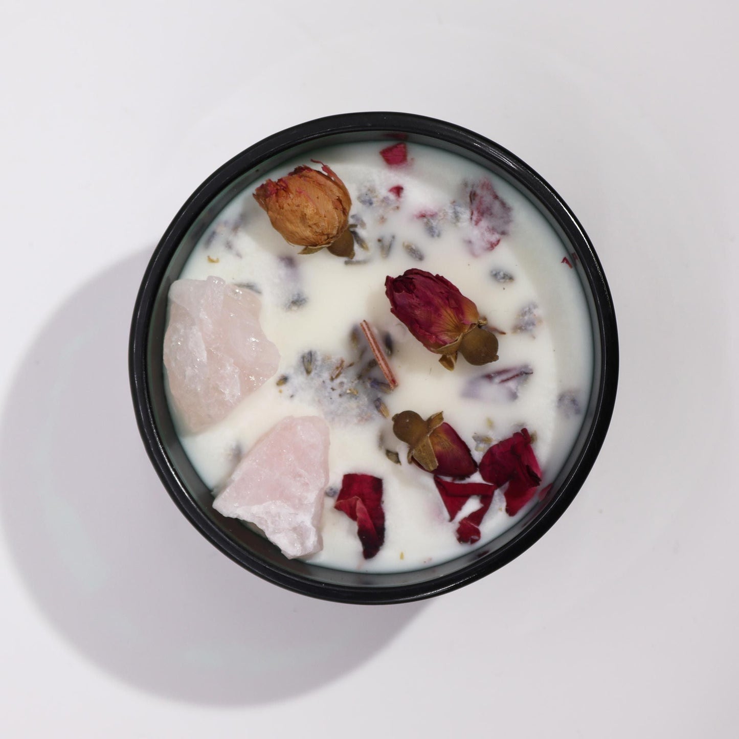 Alt Tag: Soy Wax Crystal Candle – The Lovers soy wax candle with rose quartz crystals and dried rose petals, top view in black jar