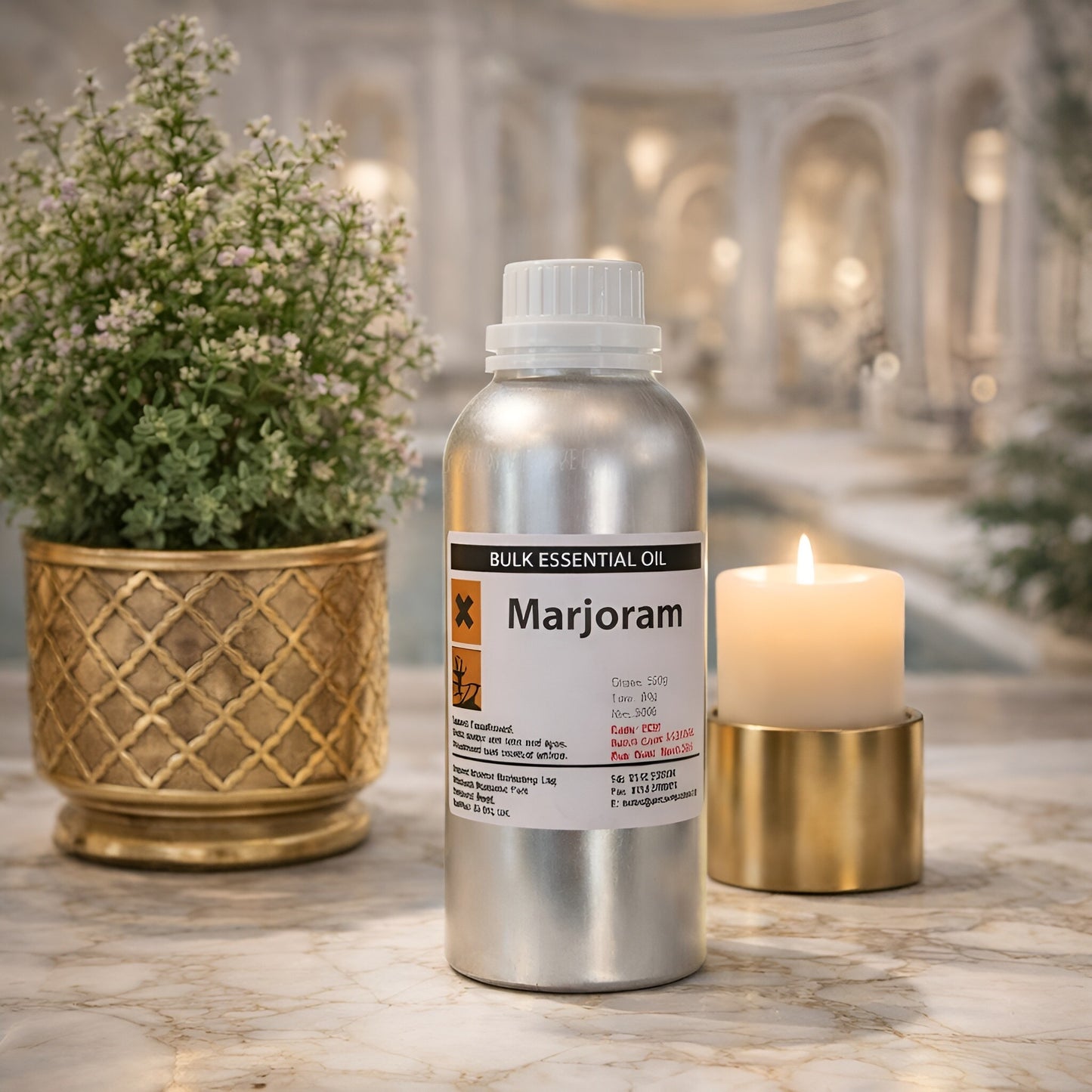 Alt Tag: Spanish Wild Marjoram Essential Oil – 0.5KG bottle of bulk marjoram essential oil on marble surface with candle and plant