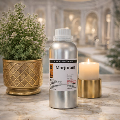 Alt Tag: Spanish Wild Marjoram Essential Oil – 0.5KG bottle of bulk marjoram essential oil on marble surface with candle and plant