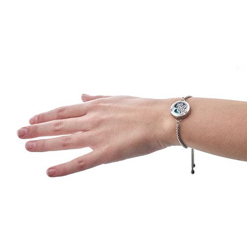 Alt Tag: Stainless Steel Aromatherapy Bracelet – Angel Wings 20MM stainless steel locket bracelet on wrist with adjustable chain