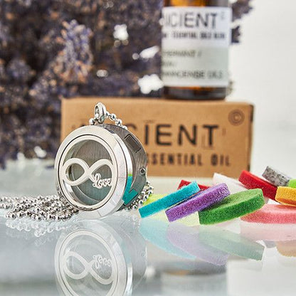 Stainless Steel Infinity Love Aromatherapy Necklace – 25MM diffuser locket with chain, felt pads and essential oil bottle in background