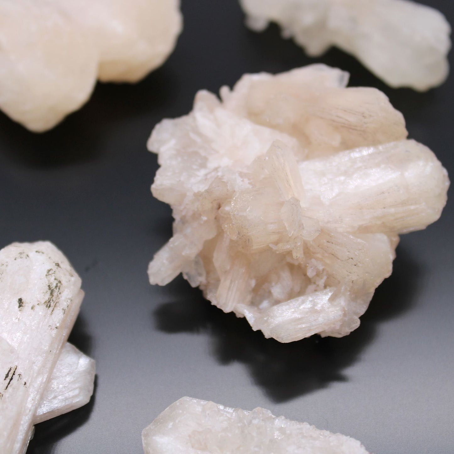 Alt Tag: Stilbite & Apophyllite Specimen – 20–30 MM, mineral specimen with pale peach stilbite rosette crystals and apophyllite on dark background