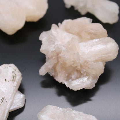 Alt Tag: Stilbite & Apophyllite Specimen – 20–30 MM, mineral specimen with pale peach stilbite rosette crystals and apophyllite on dark background