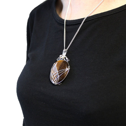 Swirl Wrapped Gemstone Necklace – Tiger Eye silver wire wrapped tiger eye pendant on chain worn over black top