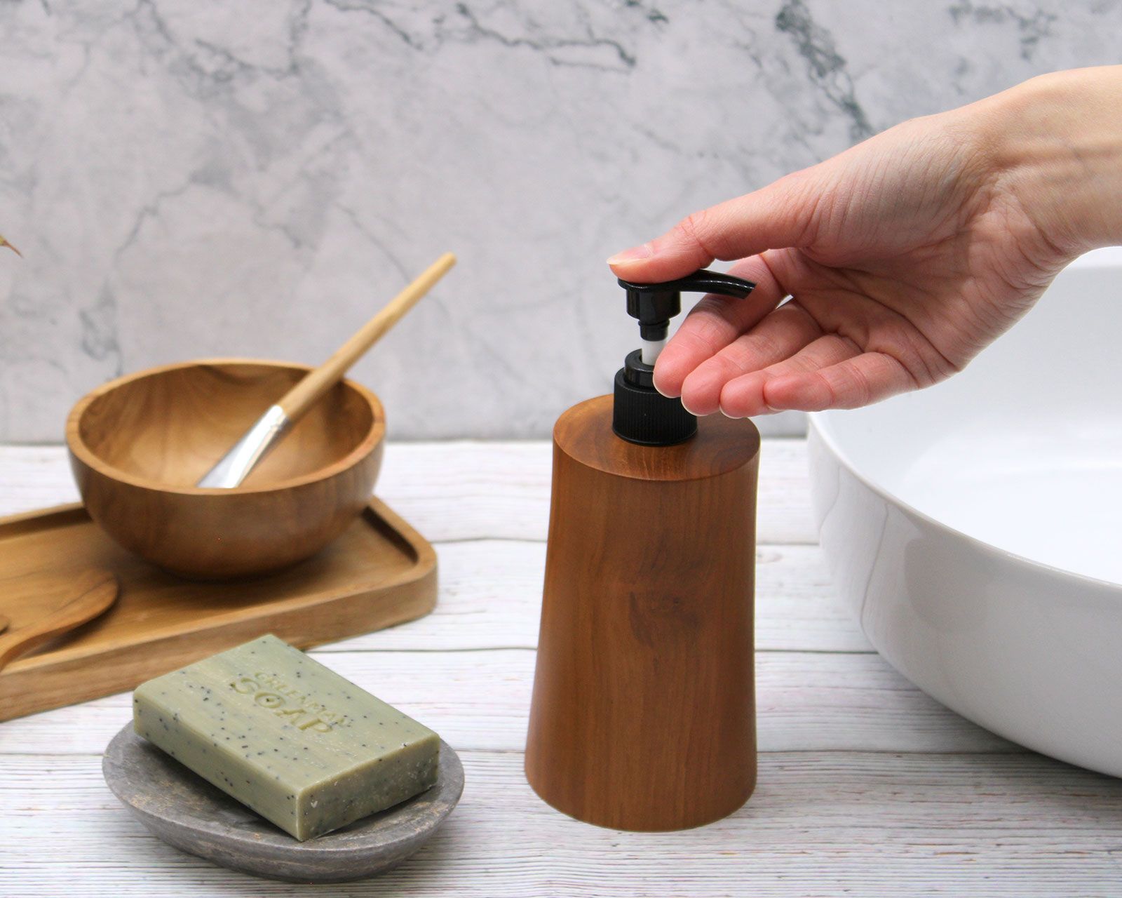 Alt Tag: Teakwood Soap Dispenser – Taper Design, tapered teak wood pump dispenser on bathroom countertop near soap bar and sink