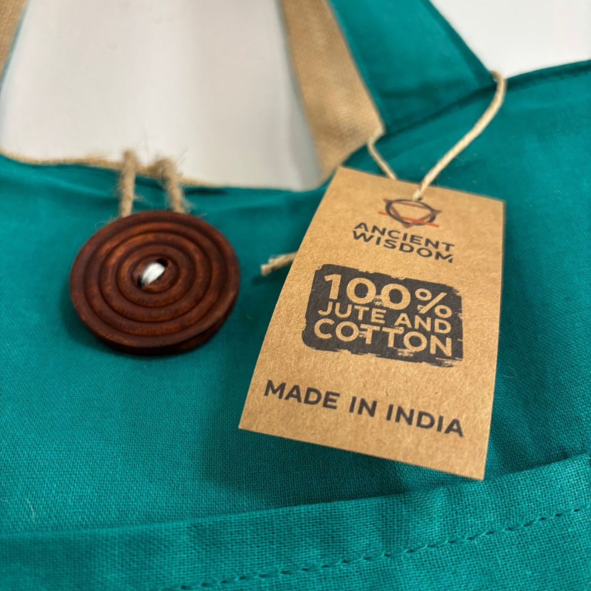 Teal Reversible Jute & Cotton Bag – 49x40 CM close-up of teal fabric with tag showing 100% jute and cotton, made in India