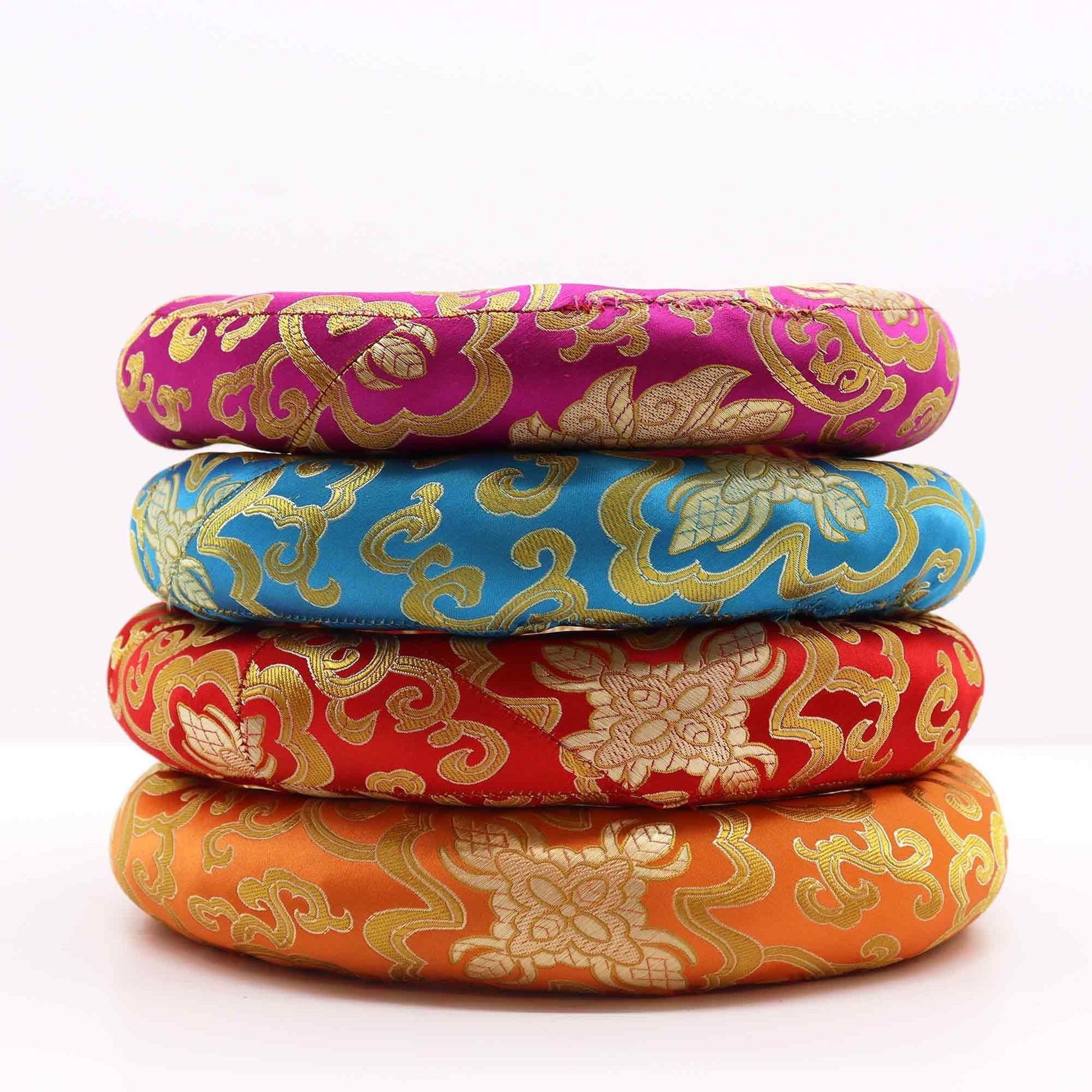 Alt Tag: Textile Polyester Hoop Cushion – 24CM brocade singing bowl ring cushion set, stacked in pink, blue, red and orange