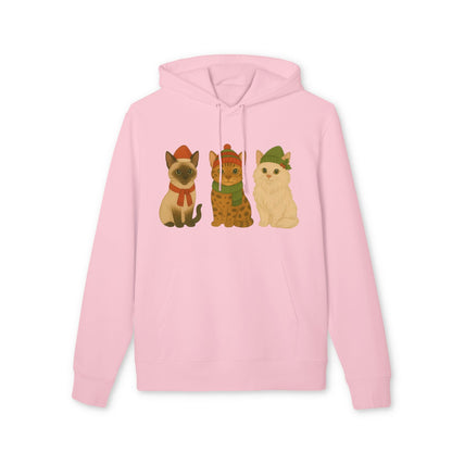 Three Little Cats Christmas Premium Unisex Hoodie rosa con tres gatos ilustrados con gorros y bufandas navideñas en el frente
