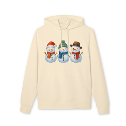 Alt Tag: Three Little Snowmen Christmas Premium Unisex Hoodie color crema con tres muñecos de nieve navideños en el pecho