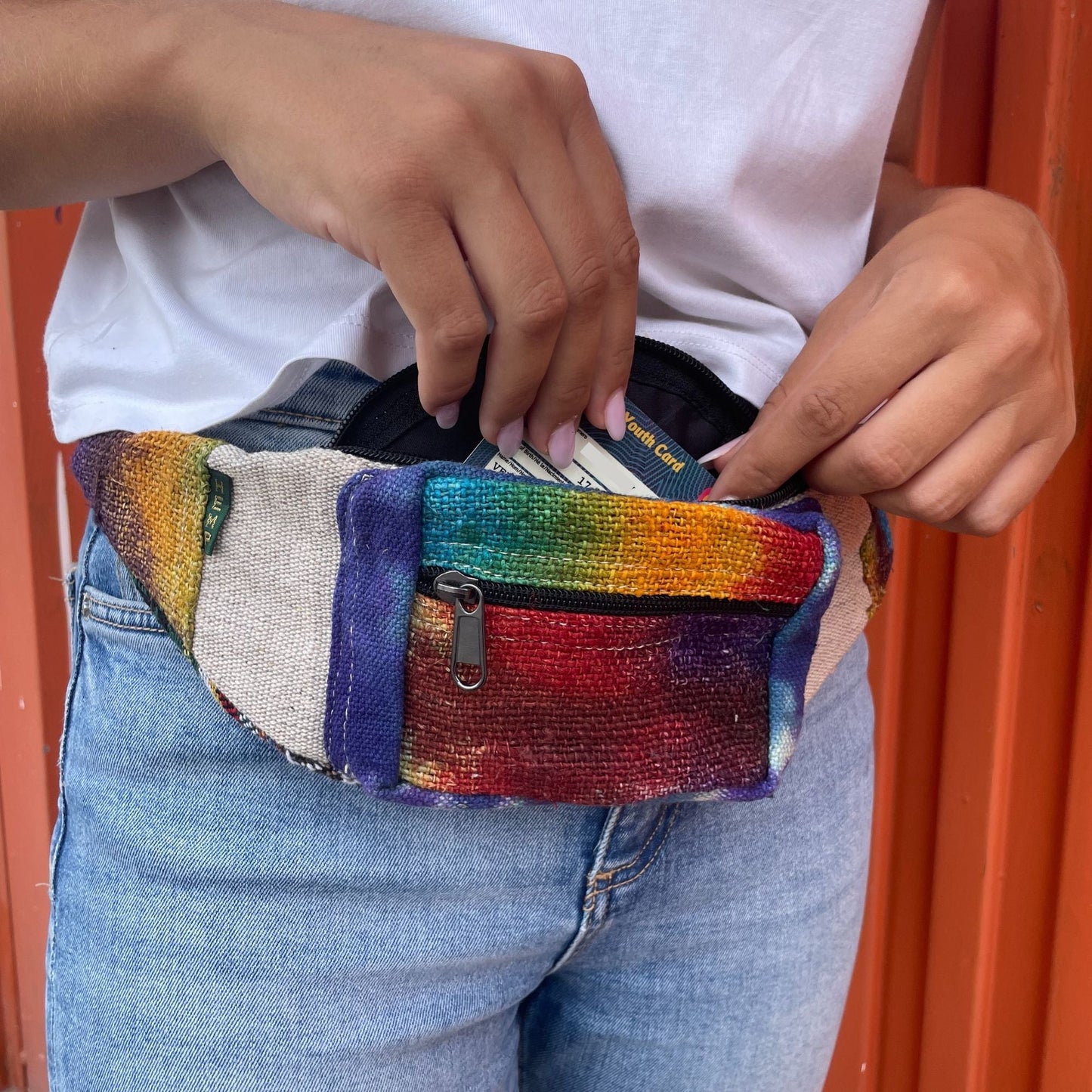 Alt Tag: Tiedye Hemp Bum Bag All Natural rainbow tie-dye hemp cotton waist bag with front zipper, worn hands-free and holding essentials