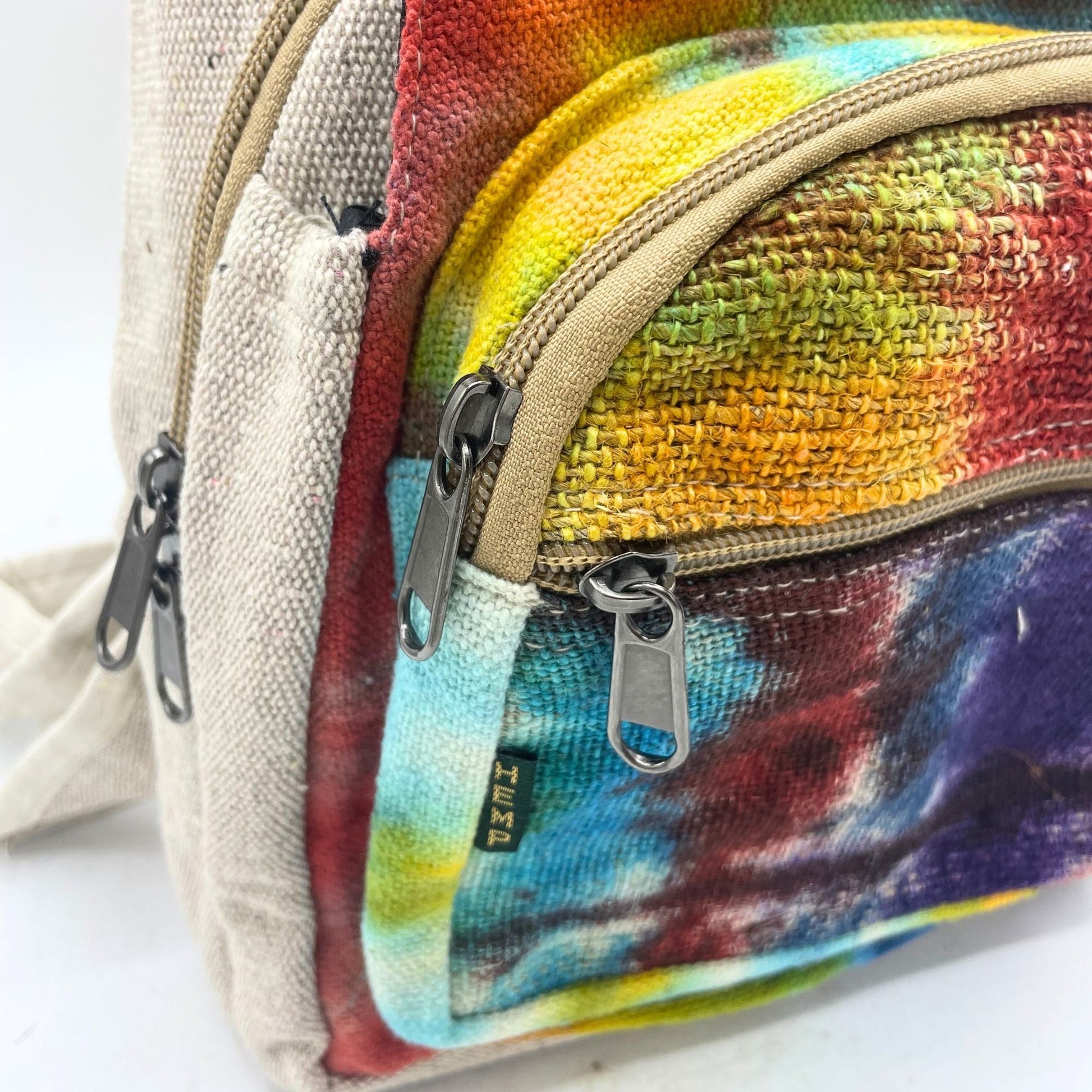 Alt Tag: Tiedye Hemp Sling Shoulder Bag All Natural From Kathmandu close-up of colorful tie-dye hemp fabric with zipper pockets and strap