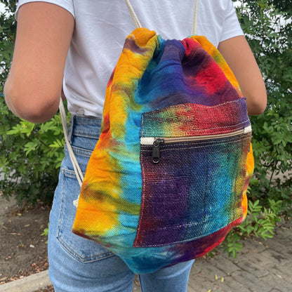 Alt Tag: Tiedye Hemp String Bag All Natural tie-dye drawstring backpack with front zip pocket, worn outdoors