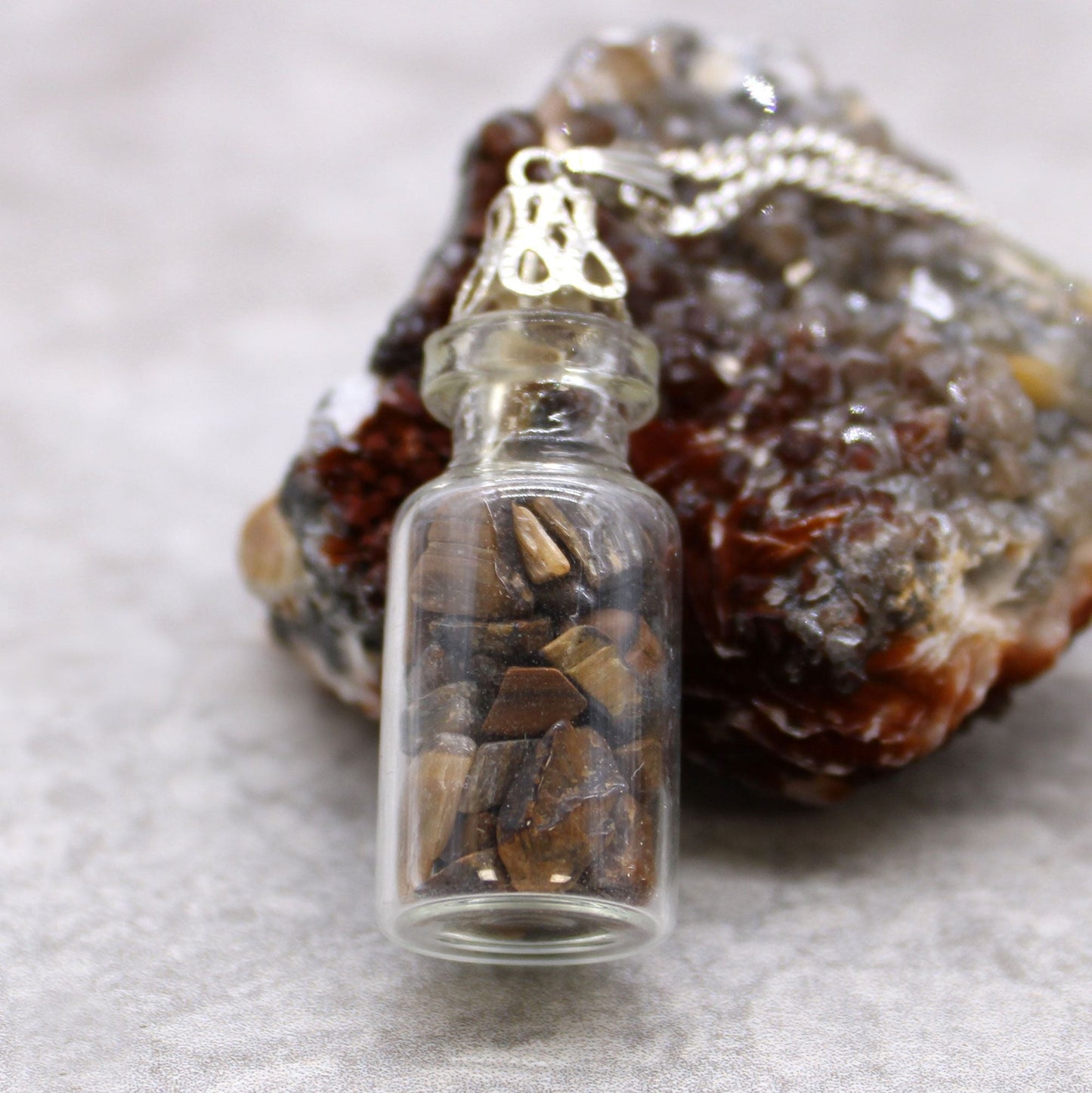 Alt Tag: Tiger Eye Bottled Gemstones Necklace – Natural Stone, mini glass bottle pendant with natural tiger eye chips on silver chain