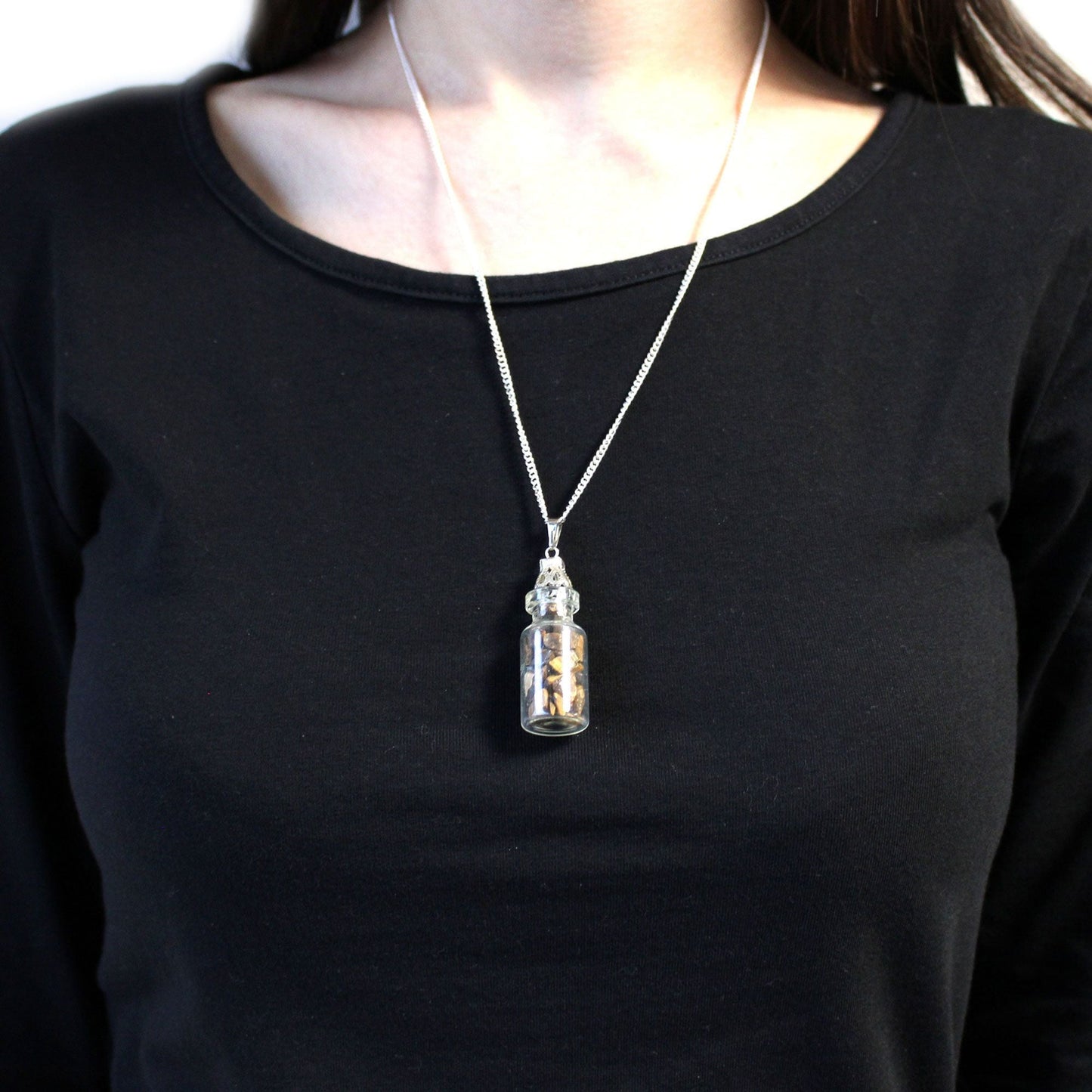 Alt Tag: Tiger Eye Bottled Gemstones Necklace – Natural Stone worn on silver chain, small glass bottle pendant with tiger eye stones