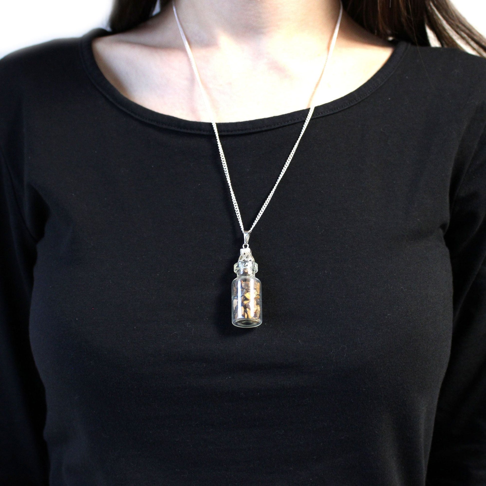 Alt Tag: Tiger Eye Bottled Gemstones Necklace – Natural Stone worn on silver chain, small glass bottle pendant with tiger eye stones