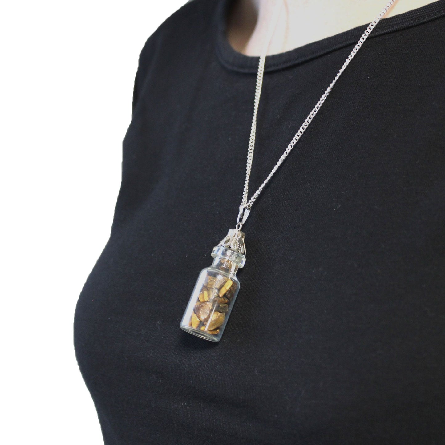 Alt Tag: Tiger Eye Bottled Gemstones Necklace – Natural Stone glass bottle pendant with tiger eye chips on silver chain, worn on black top
