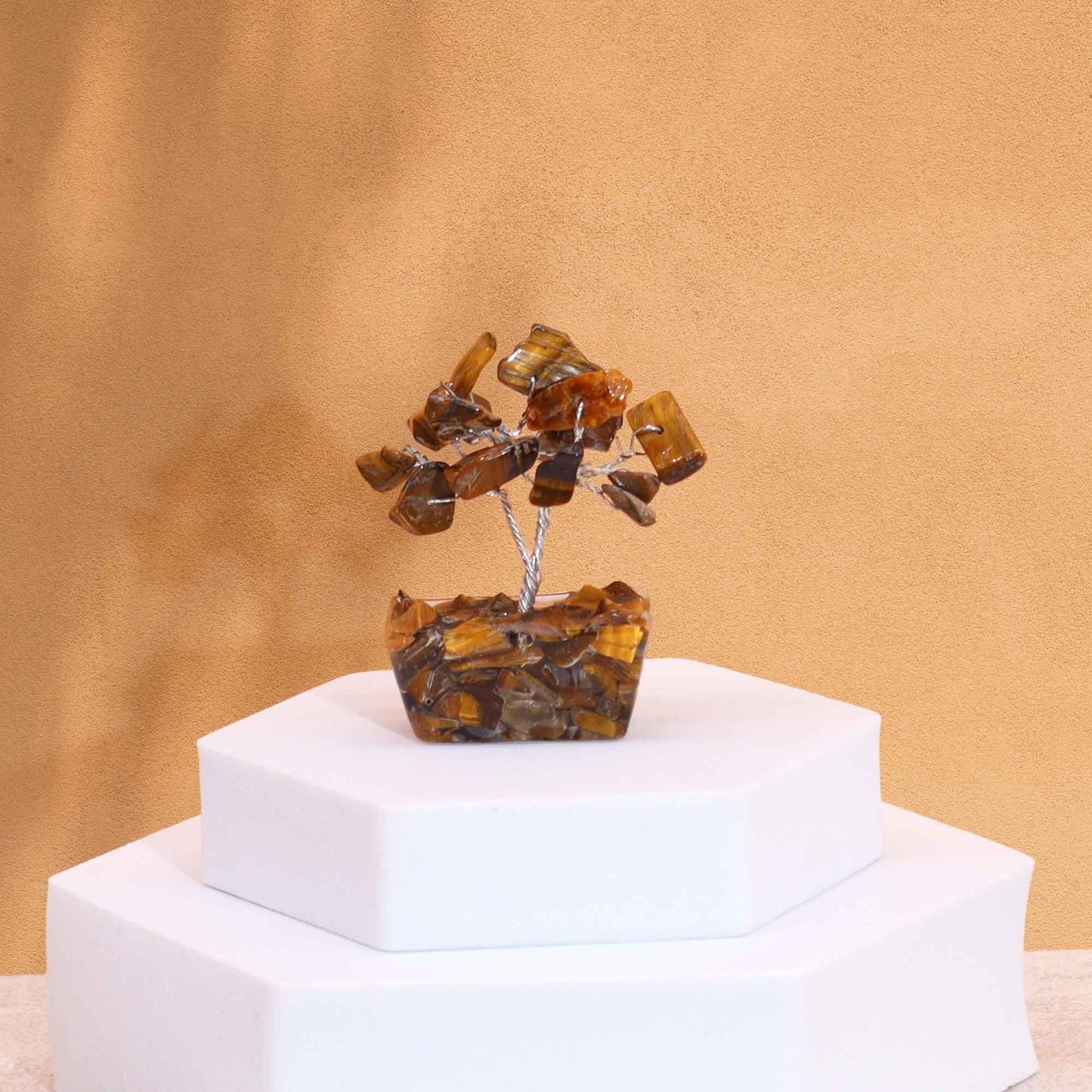 Alt Tag: Tiger Eye Mini Gemstone Tree – 15 Stones, 5CM handcrafted mini gemstone tree with orgonite base on white display podium
