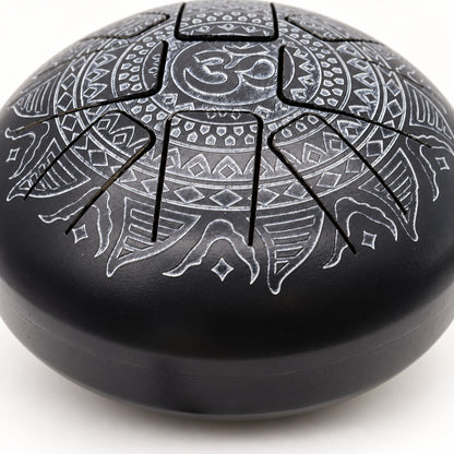 Detail of a cut tongue with silver-grey engraving and the transition into the drum's curved black sidewall.